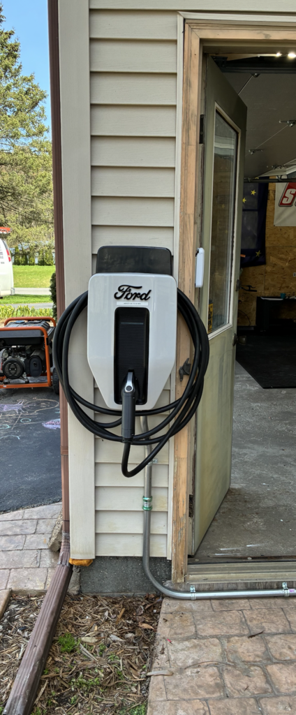 Ford EV charger mounted on exterior wall for home charging installation