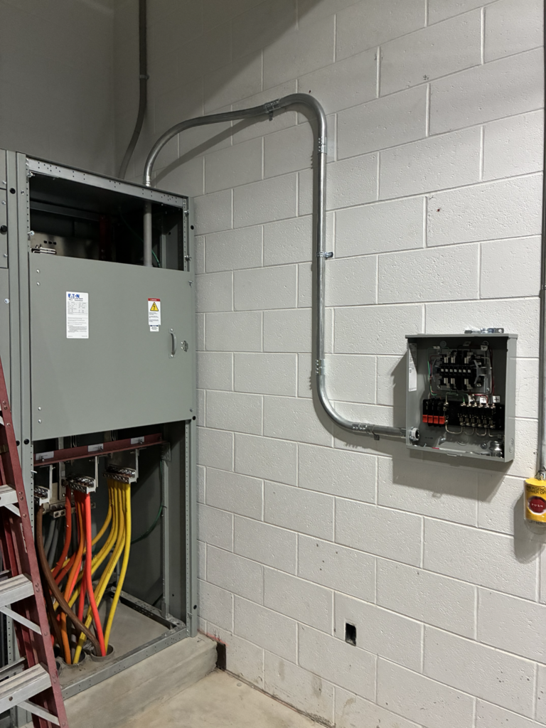 Industrial equipment and control panel wiring installed on concrete block wall by Del Haven Electric in Western Washington