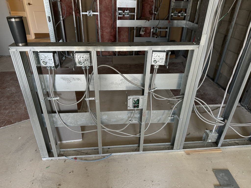 Open wall wiring during commercial electrical rough in installation