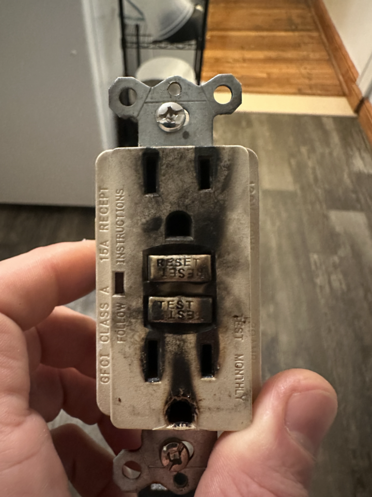 Worn electrical receptacle before replacement